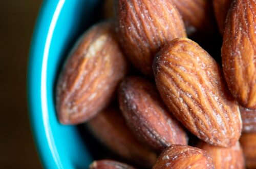 brown almond nuts on blue ceramic bowl