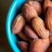 brown almond nuts on blue ceramic bowl